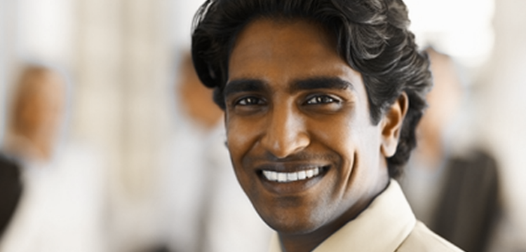 Smiling Indian businessman with blurry background