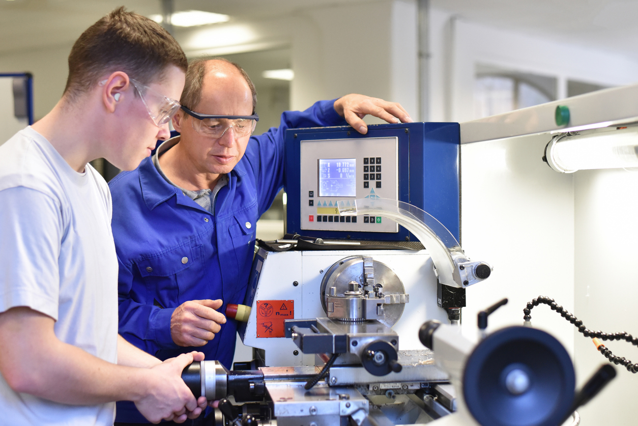 young people in technical vocational training with teacher